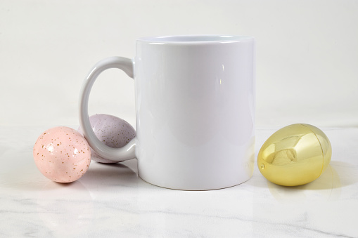 11 ounce coffee mug surrounded by colorful eggs.