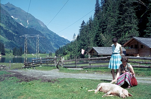 Felbertal, Salzburger Land, Austria, 1964. A holidaymaker pets a free-ranging domestic pig on the side of a path in an Alpine valley.