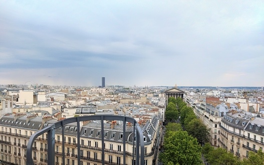 Montparnasse Tower and Madeleine Church in a stormy weather in Paris in summer