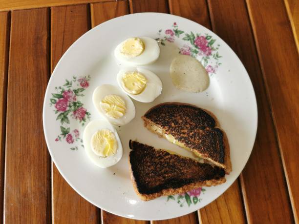 Breakfast Plate with Boiled Eggs, Toasted Bread and Cheese Sandwiches and a Homemade Garlic Sauce A Homemade Breakfast Plate with Hard-boiled Eggs, Toasted Whole Wheat Bread and Cheese Sandwiches and a Homemade Garlic Sauce. egg white boiled stock pictures, royalty-free photos & images