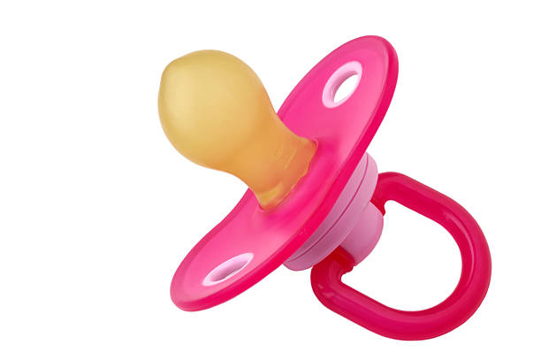 Close-up of pink pacifier over a white background stock photo