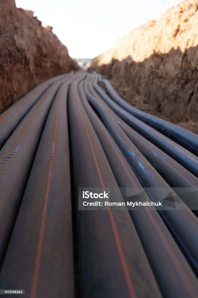 Digital telecommunication network cables are laid towards the city. Cables in Friction reduced pipe are buried underground. A large number of electric and high-speed Network cables Construction site Cable Stock Photo
