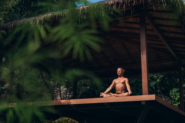 istock Man meditating in an open space yoga studio 1413162354