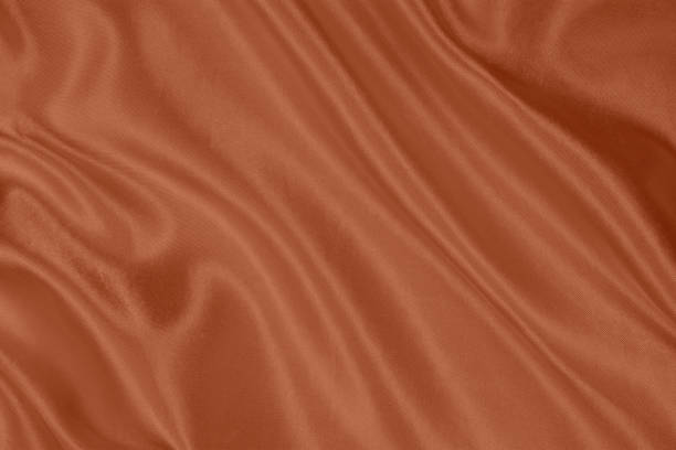 istock Beautiful Orange Silk Fabric Background 1413163002