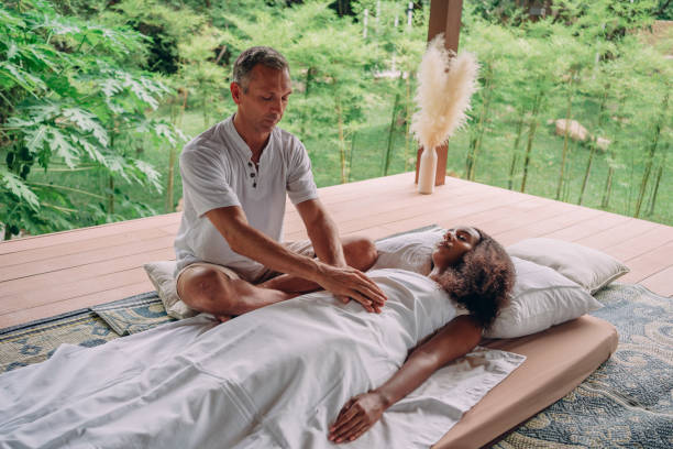 istock Woman having reiki healing treatment 1413163101