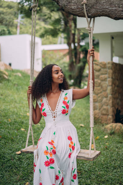 istock Woman enjoying on the swing in yard 1413163121