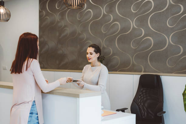 istock Receptionist asking a costumer for their signature 1413170436