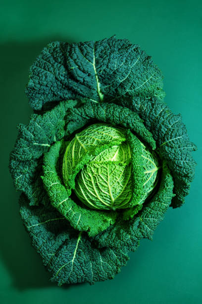 istock Savoy cabbage image over green background view from top 1413170552