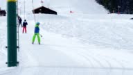 istock Boy go up holding t-bar ski lift on alpine sport vacations 1413171455