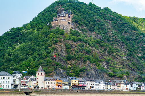 Medieval seaside village with mountain vineyards and old castle along the Rhine River in Germany.