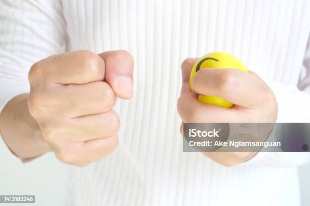 Hands Of Man With A Gentle Personality He Exhibits Stressful Behavior From Work And He Squeezes The Yellow Ball Expressing Emotion Anger Displeasure Medical Concepts And Emotional Regulation Stock Photo - Download Image Now