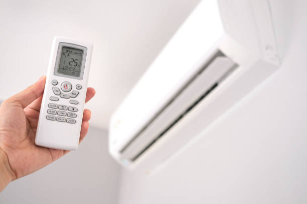 istock Man's hand using remote control open The air conditioner is cooled to 25 degrees Celsius in his bedroom. Health concepts and energy savings 1413183247
