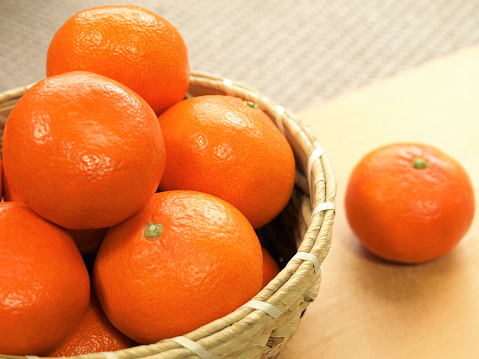 A lot of mandarin oranges in a basket.
Japanese fruit.