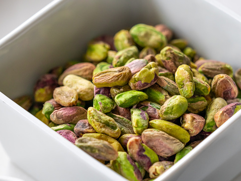 Close up of pistachios on white background, nuts, keto, healthy food