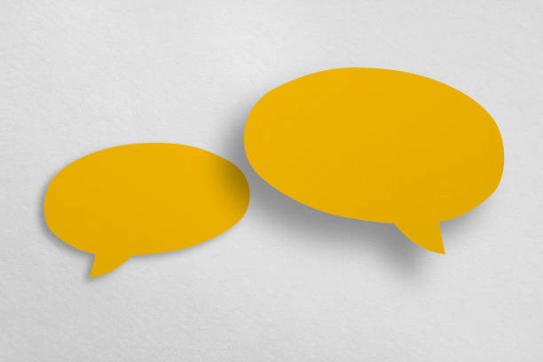 istock Speech balloon shaped yellow paper isolated on white background. 1413186465