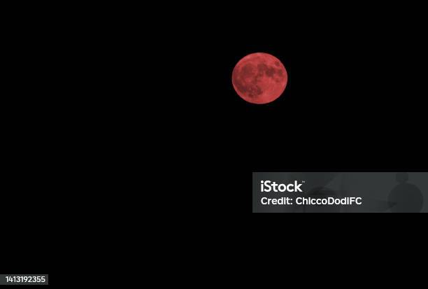 Creepy Full Red Moon That Is In The Middle Of The Black Sky Stock Photo - Download Image Now