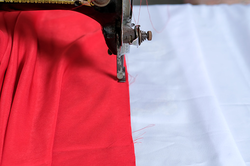 Sewing machine with red and white Indonesian national flag ahead of independence day in August