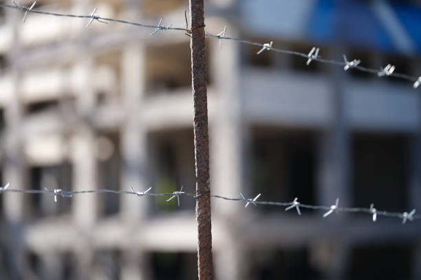 Close-up of security barbedwire fence, wire with clusters of short, sharp spikes. Fence or warfare obstruction, correctional institution concept
