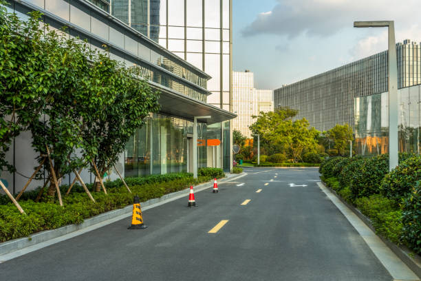 istock Empty asphalt road near glass office building 1413199849
