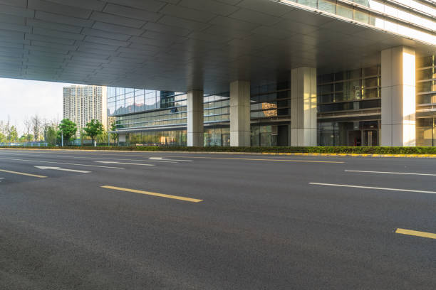 istock Empty asphalt road near glass office building 1413199861