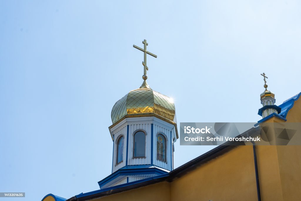 Golden cross on the dome of the Orthodox Christian Church Golden cross on the dome of the Orthodox Christian Church. Above Stock Photo