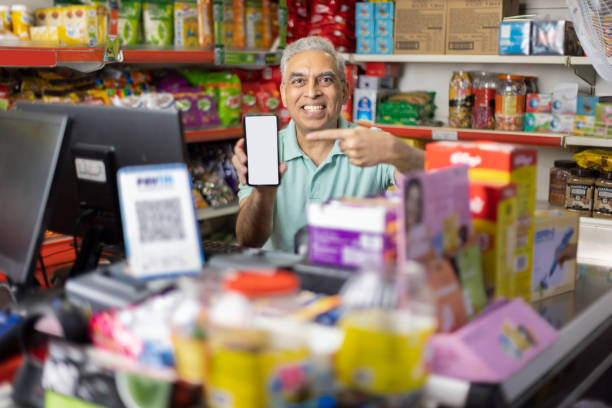 happy man working as a cashier at supermarket - retail occupation customer advice imagens e fotografias de stock