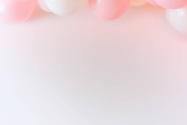 Light pink grafitti background with white and pink balloons stock photo