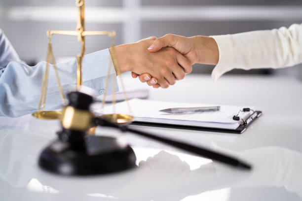 istock Lawyer Client Handshake In Courtroom 1413202231