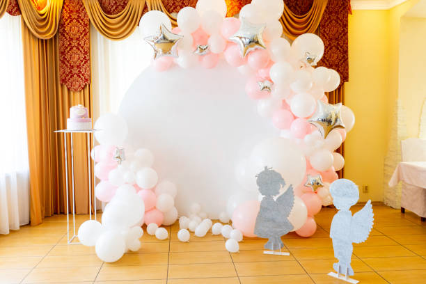 Festive photo booth with pink balloons and cake stock photo
