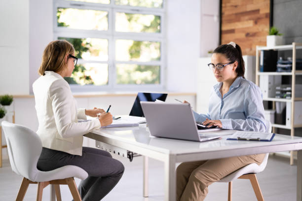 istock Two Business Colleagues Calculating Tax 1413202581