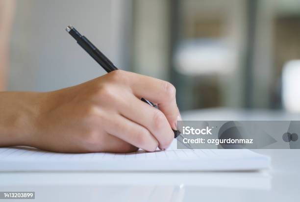 Close Up Of A Womans Hand With Pen Writing On A Notebook Stock Photo - Download Image Now