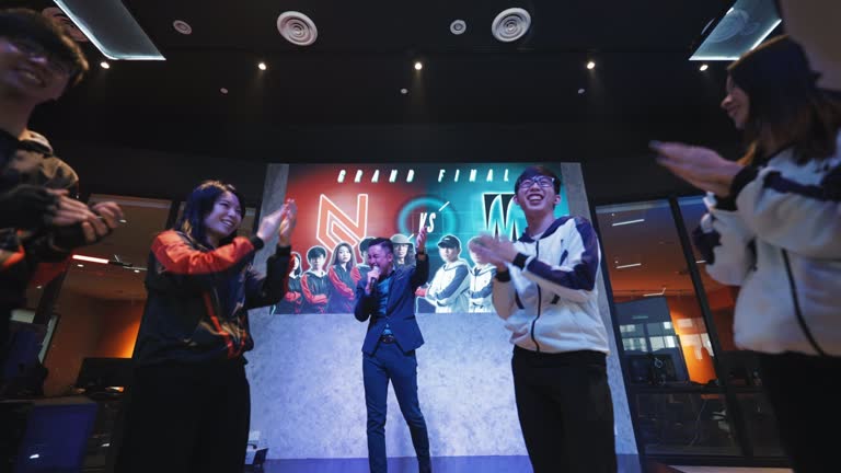 Asian Emcee Game show host introducing grand final esports team players on stage