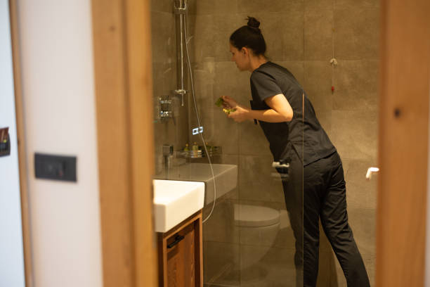 istock Young maid cleaning a hotel bathroom 1413204484