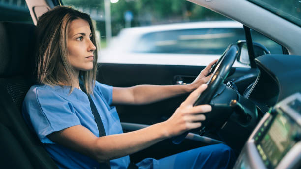 istock Female doctor driving home after a day's work 1413205244