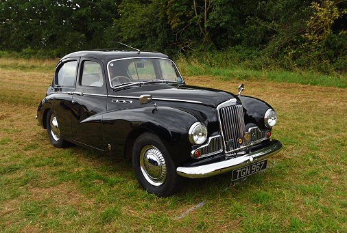 Little Gransden, Cambridgeshire, England - August 29, 2021: Classic Black Sunbeam 1956 Talbot 90 MK3 Motor Car parked isolated on grass.