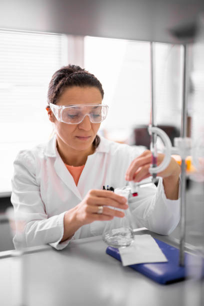 istock Female technician in a laboratory working on some medical research 1413210425