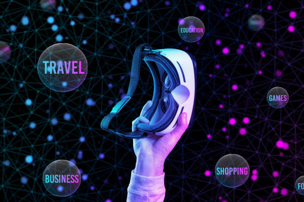 istock Virtual reality. A male hand holds VR glasses. Black background with neon abstract grid and spheres of interest. The concept of choice, cyberspace and metaverse 1413212406