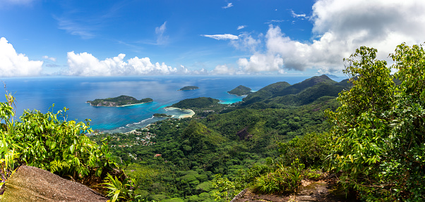 Panorama of Mahe Island, Seychelles, coastline from Morne Blanc View Point with lush tropical vegetation, crystal blue ocean and small tropical islands.