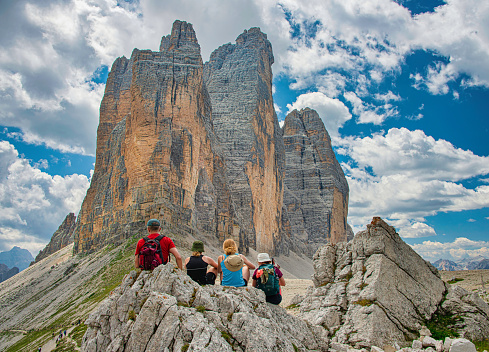 Hiker resting in front of the famous three peaks of Lavaredo, in Dolomites, Italy