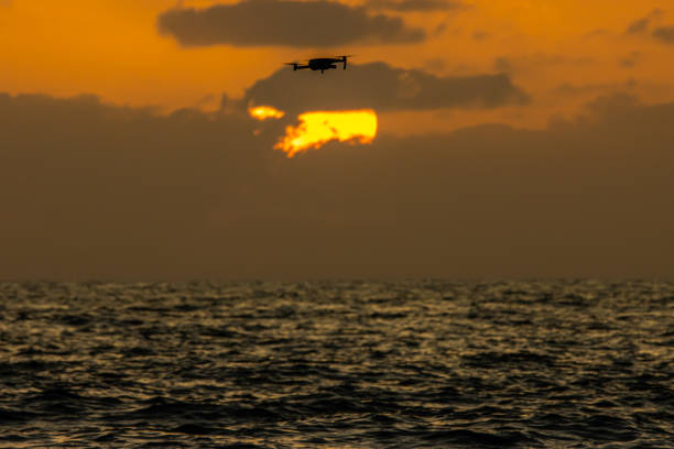 istock A big sun hiding behind clouds, drone flying infront of the sun 1413218708