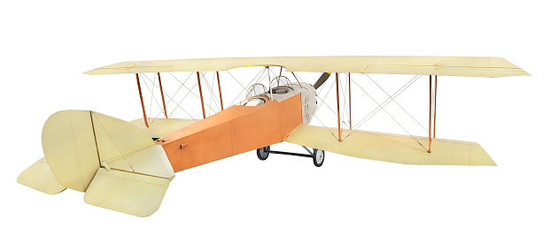Old vintage retro airplane biplane with piston engine, two-blade propeller and open cockpit. Reconnaissance aircraft of the times of the world war I. Isolated on white background