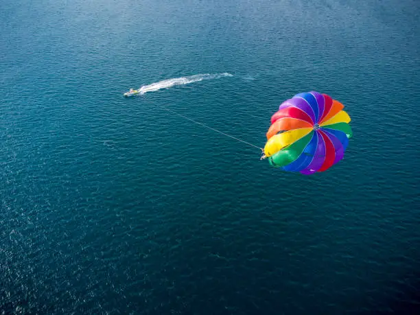 Aerial top view of the boat and parachute in the sea resort