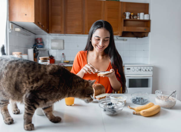 Woman Eating Bread In The Kitchen