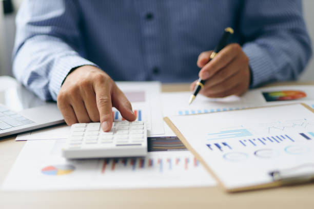 istock Businessman using a calculator to calculate numbers on a company's financial documents, analyzing historical financial data to investment planning in the future. Finance and Accounting Concepts 1413226793