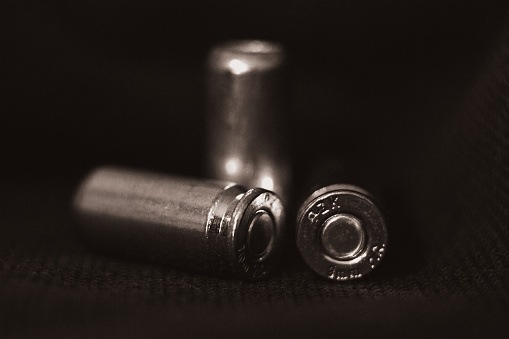 pistol bullets in black and white on a black background