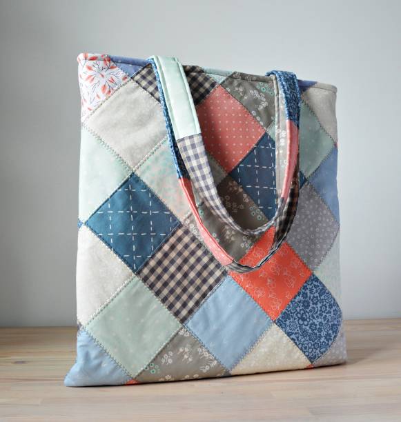 istock Blue patchwork tote bag on wooden table 1413227047