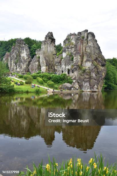 Famous Rocks Externsteine Reflecting In A Pond In Westfalia Germany Stock Photo - Download Image Now