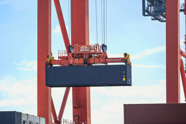 Terminal crane is moving a container in the industrial cargo por Hamburgt, concept for transport, shipping and logistics, coy space stock photo
