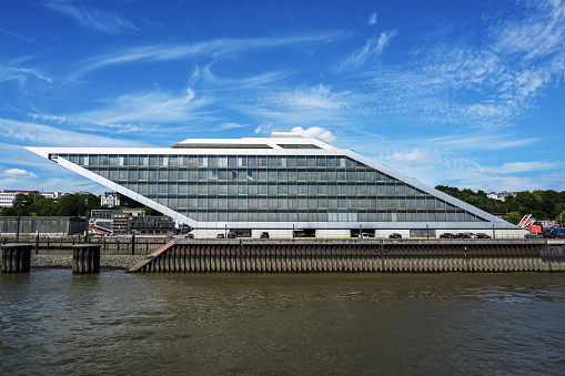 Dockland Hamburg, Germany, modern office building in the shape of a parallelogram, famous landmark and popular viewing platform, blue sky with clouds, copy space