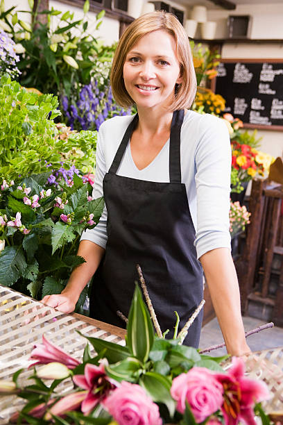 istock Woman working at flower shop smiling 141323343